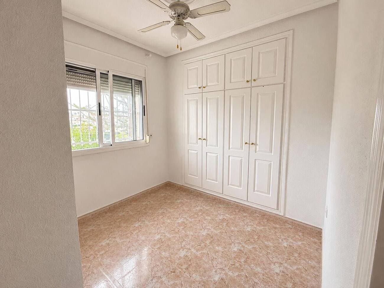 Bedroom with wardrobe and ceiling fan