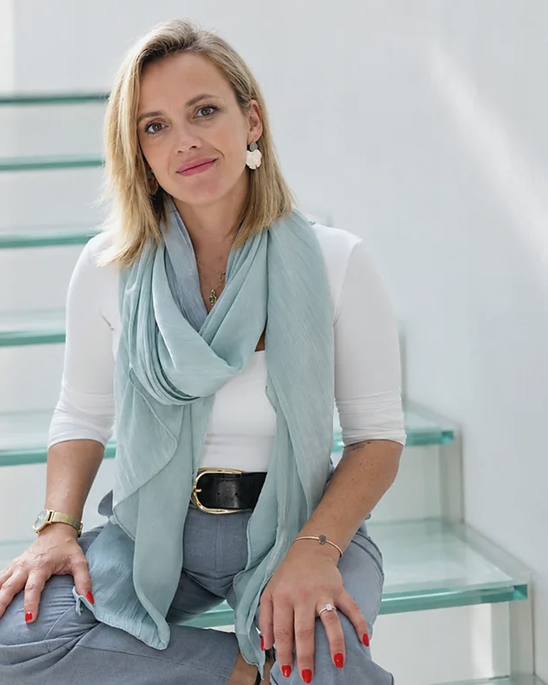 Sarah Katerina sitting on a glass staircase